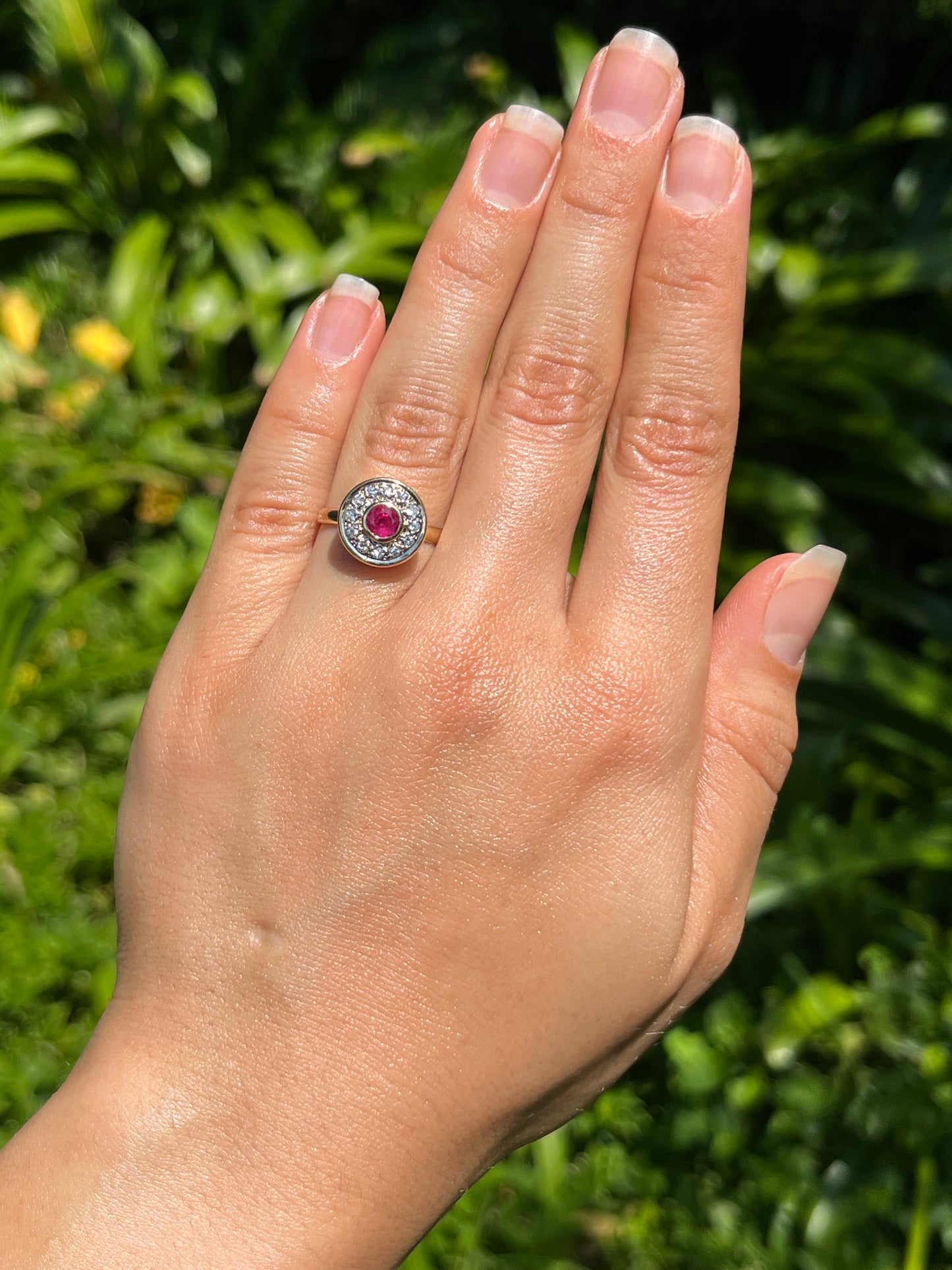 Vintage, 18K gold ruby and diamond halo ring