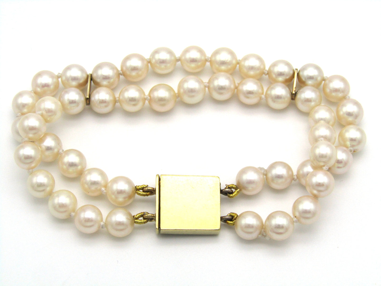 Mid-century, 18K gold double-strand cultured pearl, ruby, sapphire and emerald bracelet