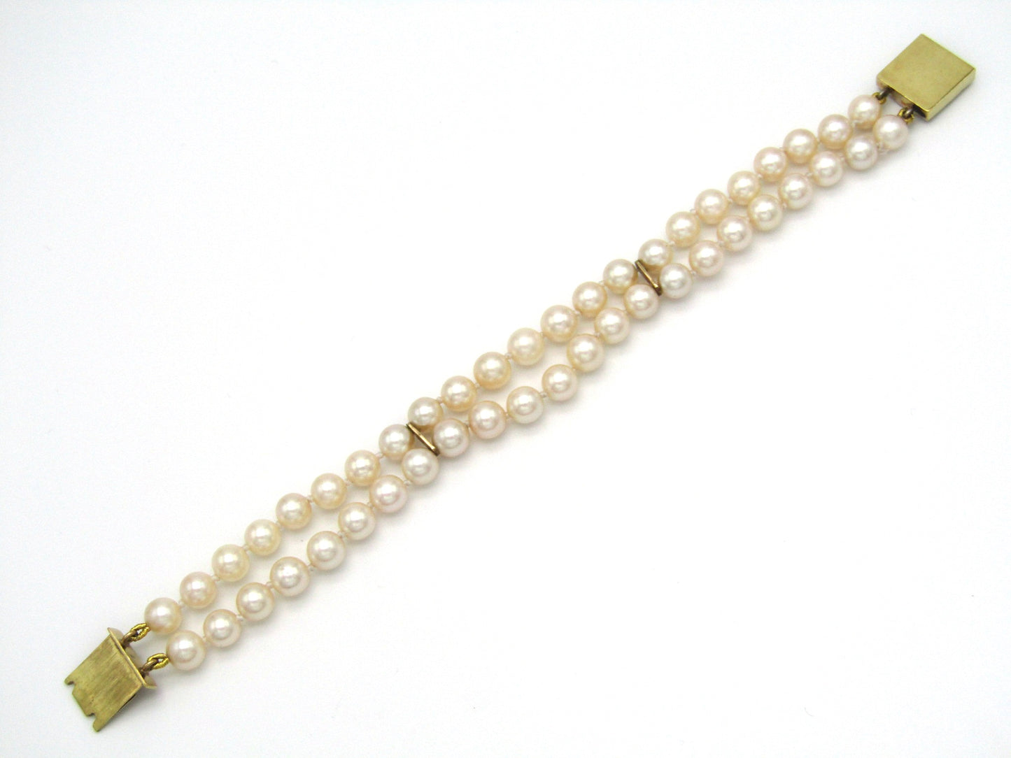 Mid-century, 18K gold double-strand cultured pearl, ruby, sapphire and emerald bracelet