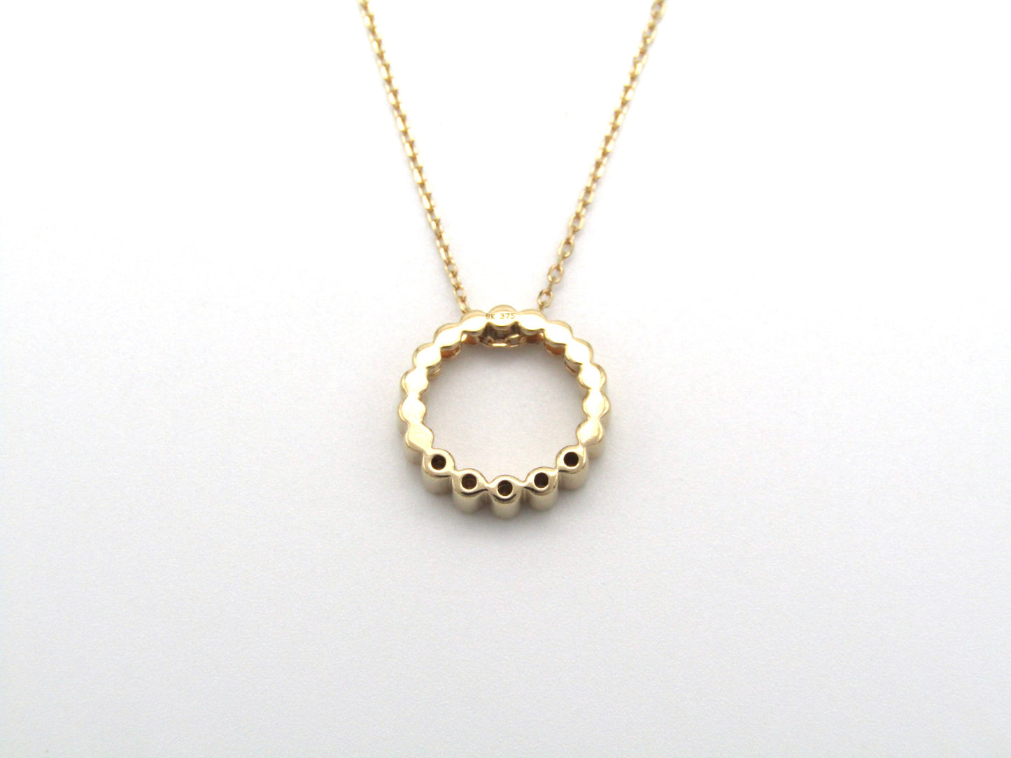 Estate, 9K gold diamond 'circle' pendant
